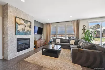 a living room with a couch and a fireplace at 4BR Home close to Airport in Aurora