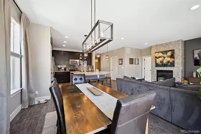 a dining room and living room with a table and a couch at 4BR Home close to Airport in Aurora
