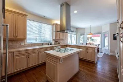 a large kitchen with wooden cabinets and a kitchen island at Luxurious 4BR Retreat - Pool Table & Chic Amenities in Boulder