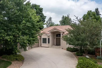 a house with a driveway leading to a garage at Luxurious 4BR Retreat - Pool Table & Chic Amenities in Boulder