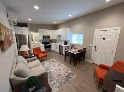 a living room with a couch and a dining room at Stylish and cozy 2 bed in Brighton