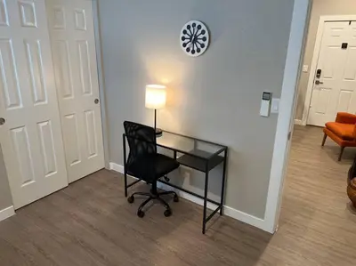 an office with a desk and a chair and a clock at Stylish and cozy 2 bed in Brighton