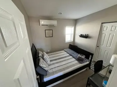 a small bedroom with a bed in a room at Stylish and cozy 2 bed in Brighton