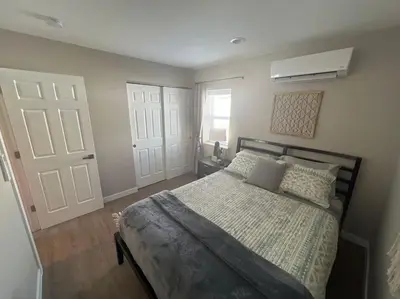 a bedroom with a bed and a white door at Elegant & cozy 2 bed in Brighton