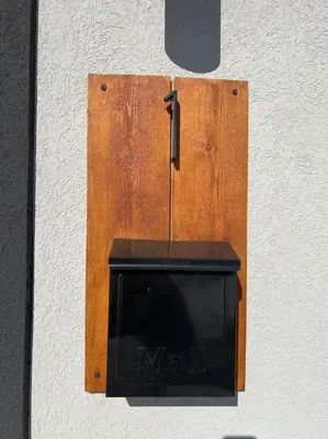 a wooden clock on a wall with a television at Elegant & cozy 2 bed in Brighton