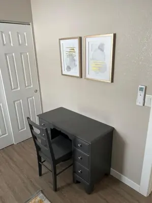 a black desk with a chair in a room at Elegant & cozy 2 bed in Brighton