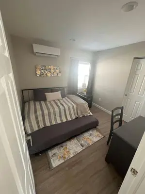 a small bedroom with a bed and a window at Elegant & cozy 2 bed in Brighton