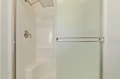 a shower with a glass door in a bathroom at NEW! 1958 Chic Mid-Mod House in Littleton