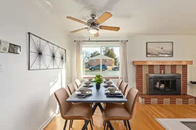a dining room with a table and chairs and a fireplace at NEW! 1958 Chic Mid-Mod House in Littleton