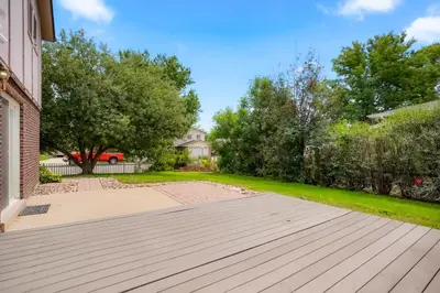 a house with a wooden walkway in a yard at Large Home, 2 Living Rooms, Great for Family/Pets! in Arvada