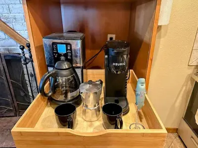a wooden cabinet with a coffee maker and a blender at Winter Haus, Winter Park 2 bedrooms corner unit w outdoor patio walking distance to the Center of town in Winter Park