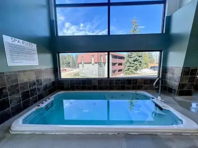 a jacuzzi tub in a room with two windows at Winter Haus, Winter Park 2 bedrooms corner unit w outdoor patio walking distance to the Center of town in Winter Park