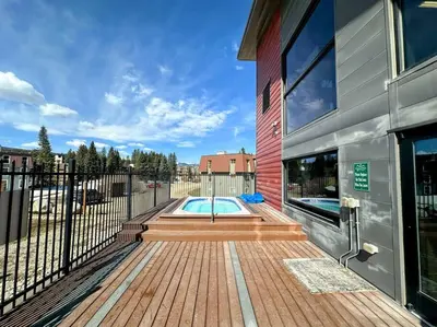 a house with a swimming pool on a wooden deck at Winter Haus, Winter Park 2 bedrooms corner unit w outdoor patio walking distance to the Center of town in Winter Park