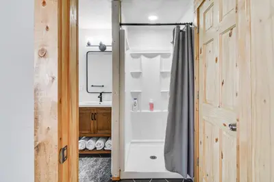 a bathroom with a shower curtain and a sink at Tabernash Home about 13 Miles to Winter Park! in Tabernash