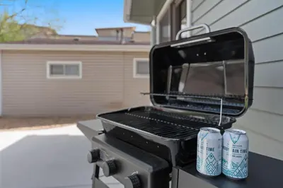 a grill with two cans on top of it at Spirit of the Rockies - Private Backyard & Hot Tub in Fort Collins