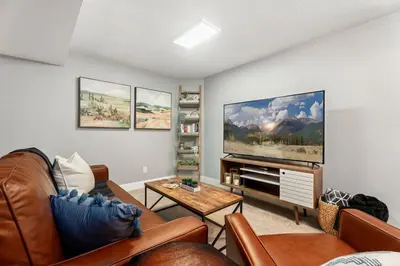 a living room with a large flat screen tv at Beautiful Old Town 2 Bedroom Apartment with Bikes! in Fort Collins