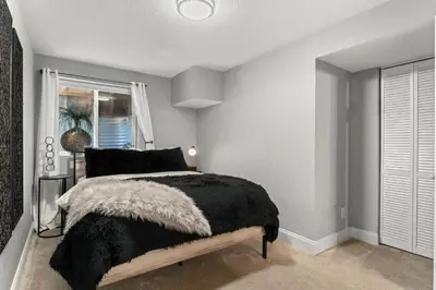 a bedroom with a black and white bed and a window at Beautiful Old Town 2 Bedroom Apartment with Bikes! in Fort Collins