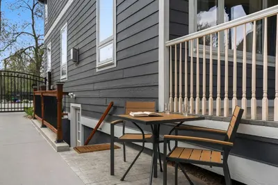 a patio with a table and chairs on a house at Beautiful Old Town 2 Bedroom Apartment with Bikes! in Fort Collins