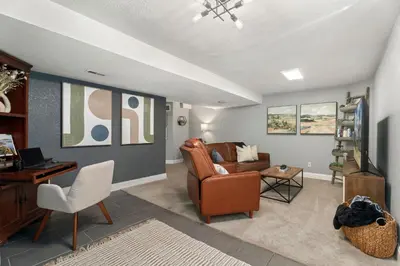 a living room with a couch and a chair at Beautiful Old Town 2 Bedroom Apartment with Bikes! in Fort Collins