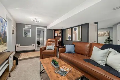 a living room with a couch and a table at Beautiful Old Town 2 Bedroom Apartment with Bikes! in Fort Collins