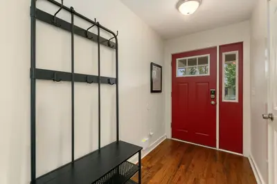 a red door in a hallway with a red door at Sherwood Cottage - Steps from Old Town & Poudre River in Fort Collins