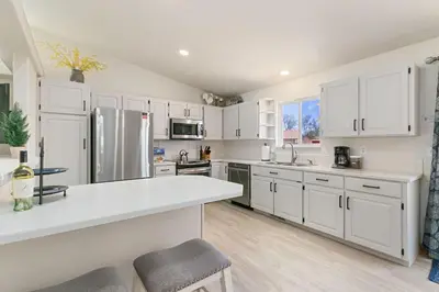 a kitchen with white cabinets and a white counter top at Colorado Mountain Retreat - Easy access to RMNP! in Loveland