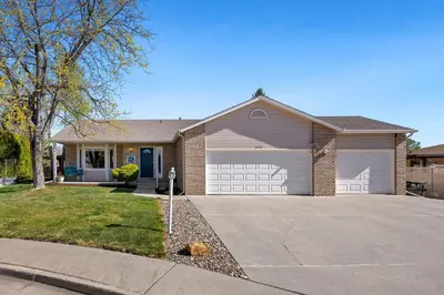 a house with a garage and a driveway at Colorado Mountain Retreat - Easy access to RMNP! in Loveland