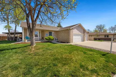 a house with a tree in a yard at Colorado Mountain Retreat - Easy access to RMNP! in Loveland