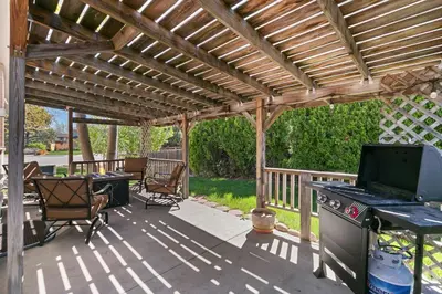 an outdoor patio with a wooden pergola at Colorado Mountain Retreat - Easy access to RMNP! in Loveland