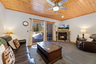 a living room with a couch and a fireplace at Bugle Pointe B04 by Estes Park Condos in Estes Park