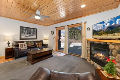 a living room with a couch and a fireplace at Bugle Pointe B04 by Estes Park Condos in Estes Park
