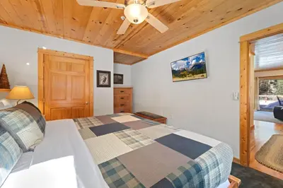 a bedroom with a bed and a ceiling fan at Bugle Pointe B04 by Estes Park Condos in Estes Park