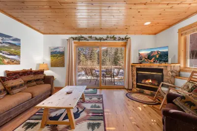 a living room with a couch and a fireplace at Bugle Pointe B06 by Estes Park Condos in Estes Park