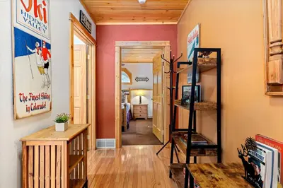 a hallway with a room with a staircase and a bedroom at Bugle Pointe B16 by Estes Park Condos in Estes Park