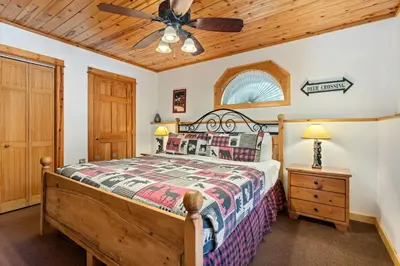 a bedroom with a bed and a ceiling fan at Bugle Pointe B16 by Estes Park Condos in Estes Park