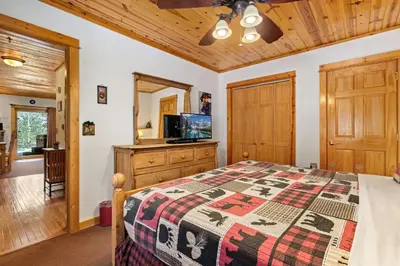 a bedroom with a bed and a wooden ceiling at Bugle Pointe B16 by Estes Park Condos in Estes Park