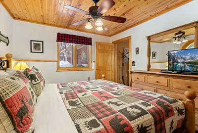 a bedroom with a bed and a ceiling fan at Bugle Pointe B16 by Estes Park Condos in Estes Park