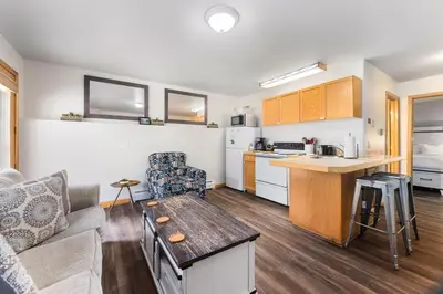 a living room with a couch and a kitchen at Creekside Suites 16 by Estes Park Condos in Estes Park