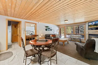 a living room with a wooden ceiling at Creekside Suites 01 by Estes Park Condos in Estes Park