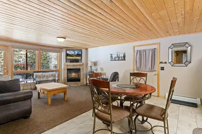 a living room with a table and a couch at Creekside Suites 01 by Estes Park Condos in Estes Park