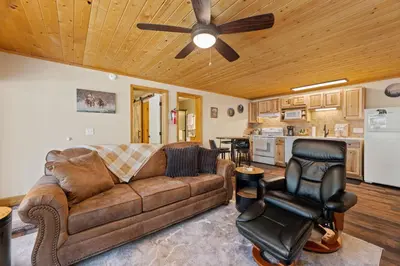 a living room with a couch and a ceiling fan at Creekside Suites 06 by Estes Park Condos in Estes Park