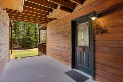 an entrance to a wooden house with a door at Creekside Suites 06 by Estes Park Condos in Estes Park