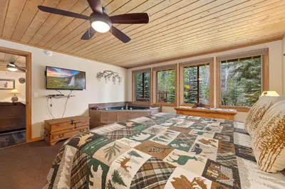 a bedroom with a bed and a ceiling fan at Creekside Suites 06 by Estes Park Condos in Estes Park