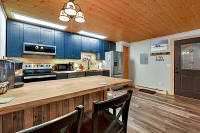 a kitchen with blue cabinets and a wooden counter top at Creekside Suites 12 by Estes Park Condos in Estes Park