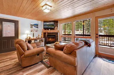 a living room with two couches and a fireplace at Creekside Suites 12 by Estes Park Condos in Estes Park