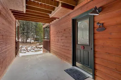 a hallway of a wooden house with a door at Creekside Suites 12 by Estes Park Condos in Estes Park