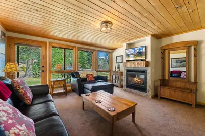 a living room with a couch and a fireplace at Creekside Suites 17 by Estes Park Condos in Estes Park
