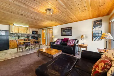 a living room with a couch and a table at Creekside Suites 17 by Estes Park Condos in Estes Park