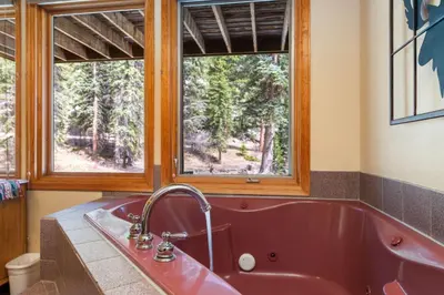 a red tub in a bathroom with a window at Creekside Suites 17 by Estes Park Condos in Estes Park