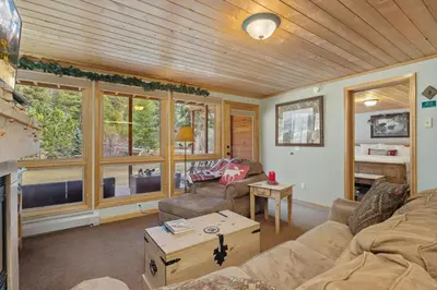 a living room with a couch and a table at Creekside Suites 22 by Estes Park Condos in Estes Park